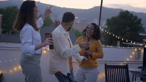 Slow motion three young multi-ethnic friends hanging out dancing enjoying Stock Footage 242292186