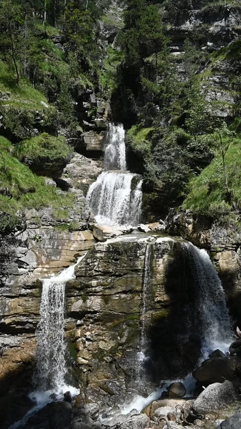 Slow motion of a threefold waterfall in summer, vertical shot Stock-Footage 260869210
