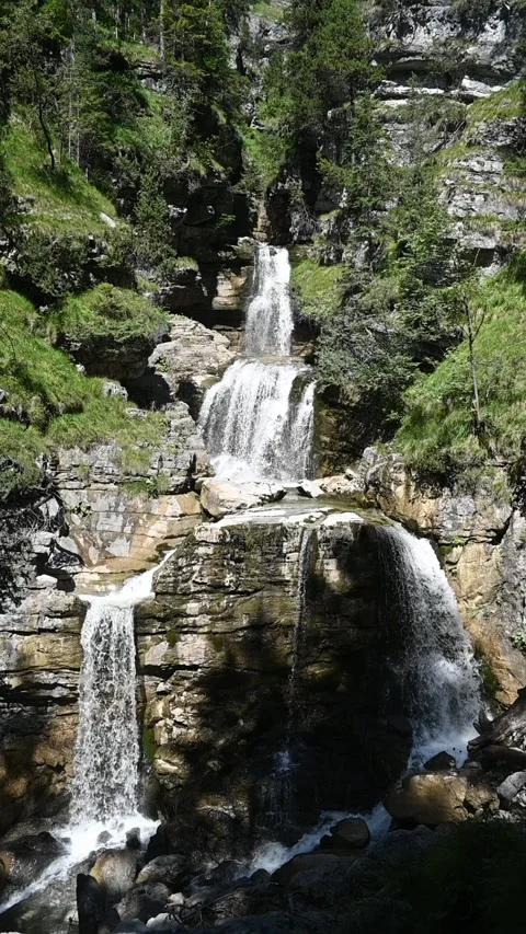 Slow motion of a threefold waterfall in summer, vertical shot Stock Footage 260869213