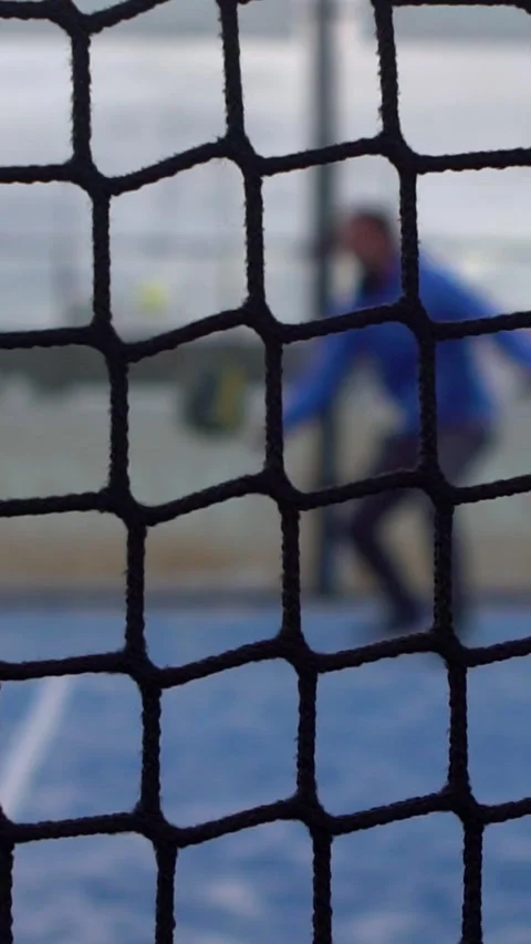 Slow motion through grid view of paddle tennis man playing on court outdoors Stock Footage 312114414