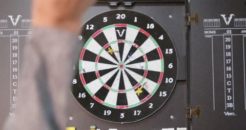 Slow motion throwing dart and hitting bullseye on target Stock Footage 230985465