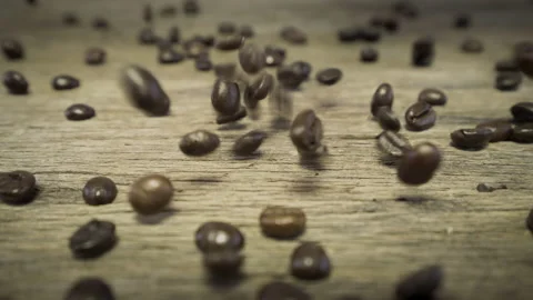 Slow motion throwing fresh coffee beans to a pile of coffee grain Stock Footage 146347897