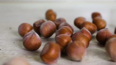 Slow motion of throwing hazelnuts on the table Stock Footage 140130426