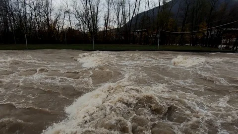 Slow motion tilt down flooded rapid chaotic river in Tacen Stock Footage 120785864