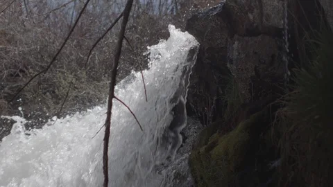 Slow Motion Tilt Down of Powerful Waterfall Stock Footage 95990198