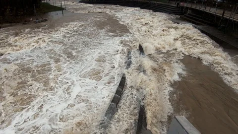 Slow motion tilt down raging brown flooded water Stock Footage 122204470