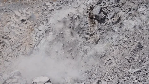Slow motion tilt down on rock fall Stock Footage 126903826