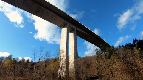 Slow motion tilt down under huge concrete highway viaduct Stock Footage 121679787