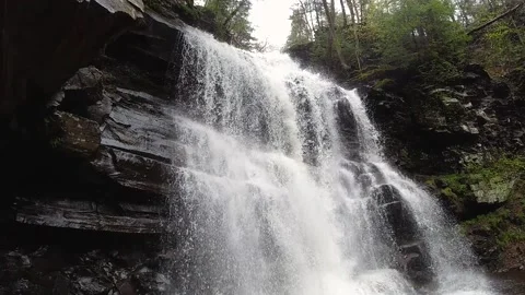 Slow Motion tilt down view of large waterfall in the forest Stock Footage 170017811