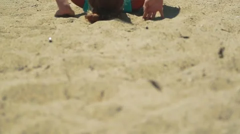Slow motion tilt up of girl practicing gymnastics at beach Stock Footage 63885775
