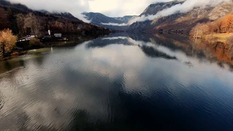 Slow motion tilt up reflection of calm surface water in lake Bohinj Stock Footage 122152612