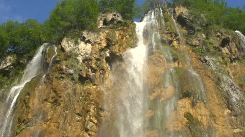 Slow motion tilt with water falling down a waterfall Stock Footage 40262325