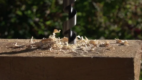 Slow motion of timber drilling on summer farm background. Stock Footage 100238885