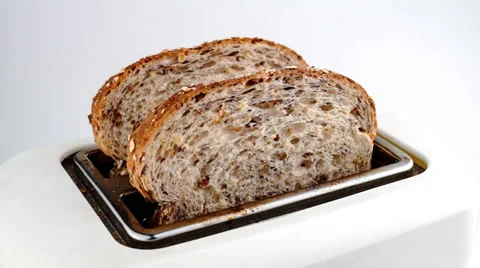 Slow motion time lapse of multi-grain whole wheat bread being toasted and Stock Footage 46880980
