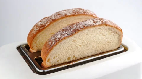 Slow motion time lapse of white bread being toasted and popping out of toaster Stock Footage 46880385
