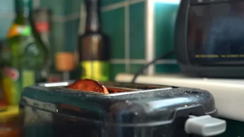 Slow motion toast pops up from a kitchen toaster, fresh bread jumping after Stock Footage 330847995