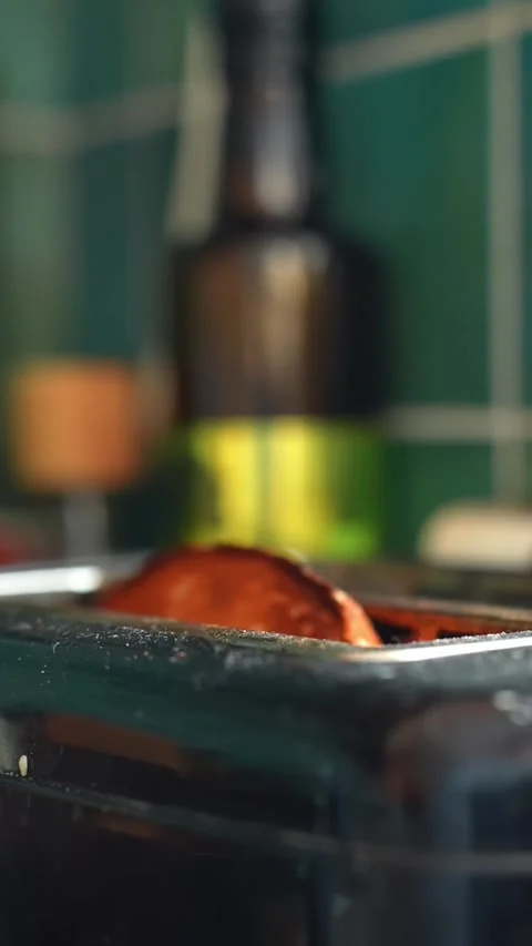 Slow motion toast pops up from a toaster in a cozy kitchen, golden bread rising Stock Footage 332044570