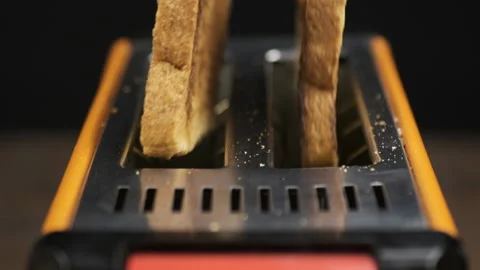 Slow motion. Toasted bread slices jump out of the toaster. Stock Footage 133710163