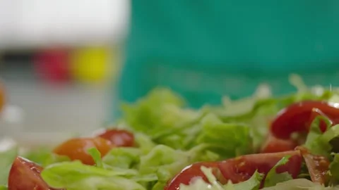 Slow Motion Tomato Wedges Falling onto Fresh Green Salad 4K Vídeos de archivo 347364309