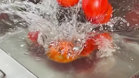 Slow Motion Tomatoes Falling into Water, Red Vegetable Splash in Kitchen Sink Stock Footage 338157957