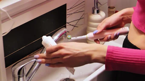 Slow Motion Toothpaste Application on Electric Brush - Morning Hygiene Scene Stock Footage 306763361