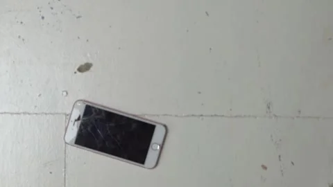 Slow Motion Top Down Of Smart Phone Falling and Landing Face Up On The Vidéo 153887456