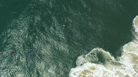 Slow motion top-down surfers as giant waves roll past Stock Footage 112707012