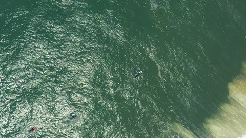 Slow motion top-down surfers as giant waves roll past 2 Stock Footage 112707192