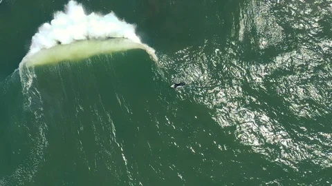 Slow motion top-down surfers as giant waves roll past 4 Stock Footage 112707979