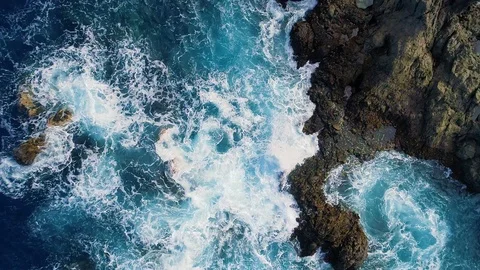Slow motion top down view of waves and clifs Stock Footage 86409544