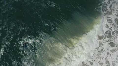 Slow-motion top-down view of crashing wave and surfers Stock Footage 112708986