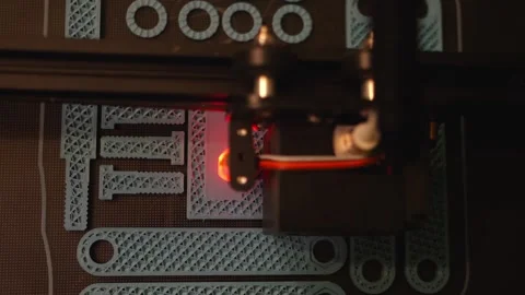 A slow motion top down view as a 3D printer builds a number of plastic Video stock 201226915