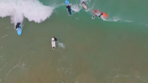 Slow motion top down view of surfer bailing as wave crashes over and sucks Stock Footage 238731563
