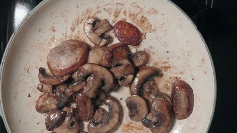 Slow Motion Top-Down View of Sizzling Mushrooms in Butter Stock Footage 317401367