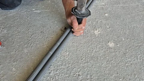 Slow motion top-down view of electrician using a hammer on anchor 스톡 동영상 345665695