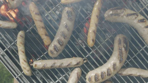 Slow motion top view camera pans over grilled sausages Stock Footage 145831593