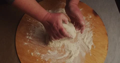 Slow motion top view close-up. A woman kneads yeast dough on a cutting board Stock Footage 259275367