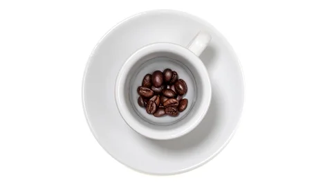 Slow motion top view of coffee beans in a white cup Stock Footage 130026951