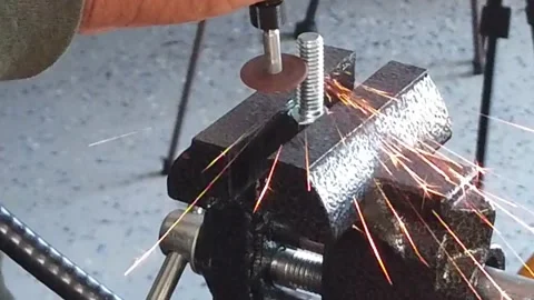 Slow Motion Top View Cutting A Metal Washer With Dremel Tool Stock Footage 219128671