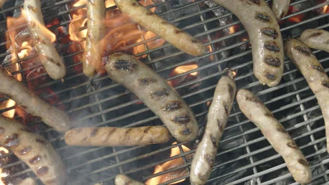 Slow motion top view grilled sausages spinning and roasting Stock Footage 145830678