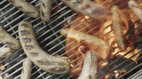 Slow motion top view of grilled sausages spinning and browning Stock Footage 145830724