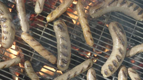 Slow motion top view grilled sausages spinning and roasting Stock Footage 145831176