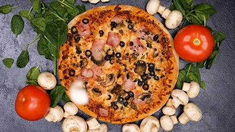 Slow motion top view shot on cutted mushrooms falling on delicious pizza Stock Footage 84788278