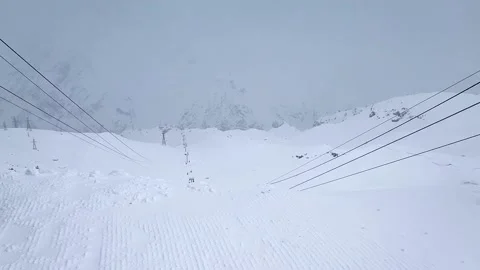 Slow motion. Top view of the snow-capped mountain slopes and the cable car in Stock Footage 166092722