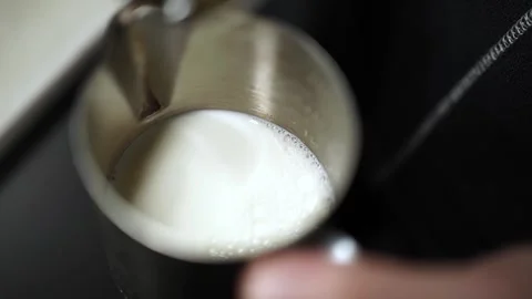 Slow Motion Top View of Syrup Pouring into Milk Pitcher Stock Footage 312261195