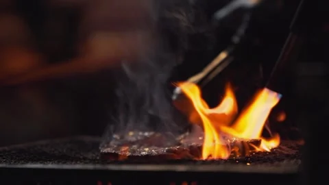 Slow motion of torch flame heating grill plate at Japanese yatai night market Stock Footage 321296340
