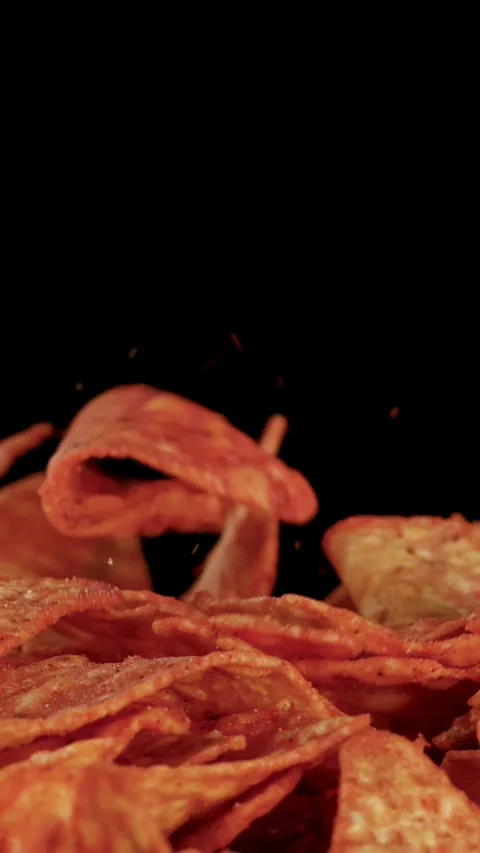 Slow Motion Tortilla Chips Dropping Onto Pile Against Black Background Stock Footage 321786293