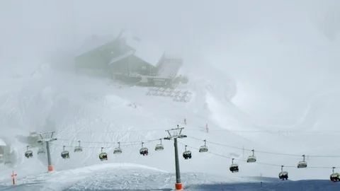 Slow motion of tourists using cabins of cable railway to travel up mountains Stock Footage 129091242