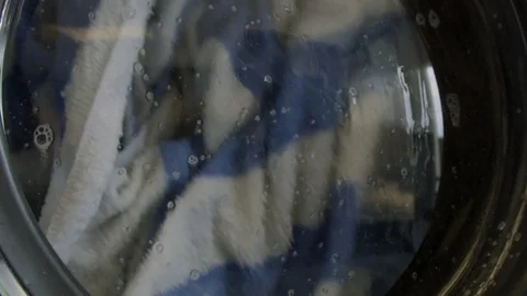Slow motion of towels being washed in washing machine Stock Footage 117626513