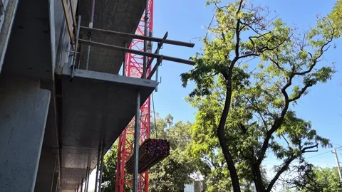 Slow motion tower crane lifting timber joists at house build Stock Footage 337485004